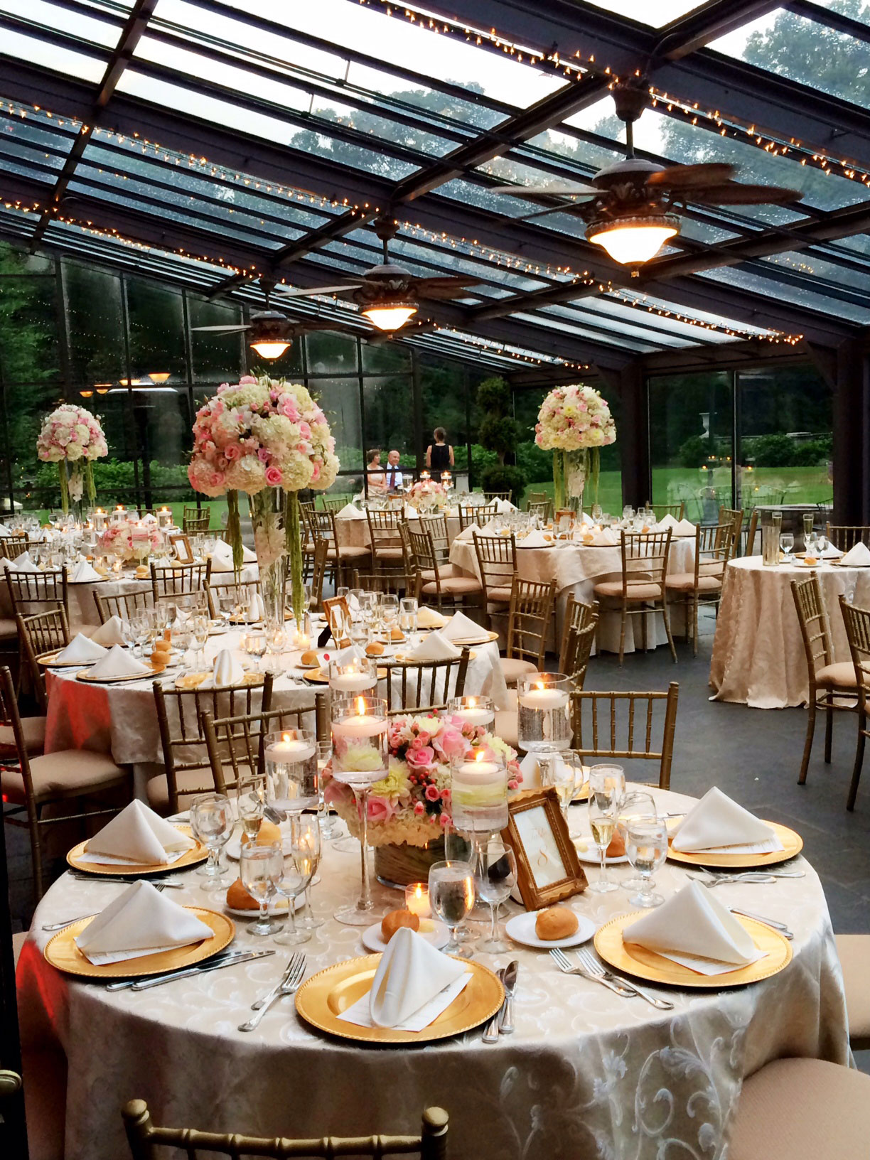 The glass-roofed reception room set for a wedding